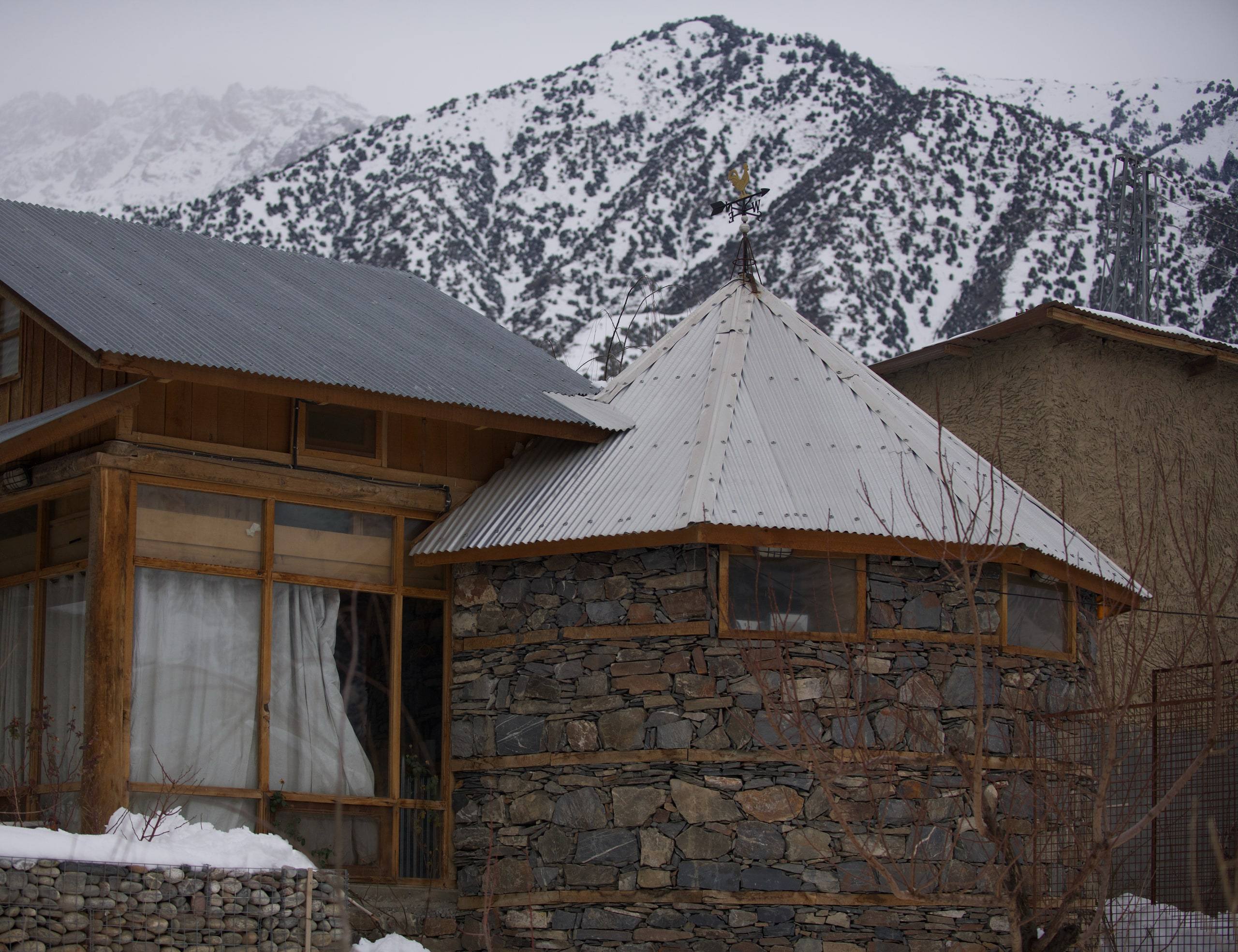 Stone-and-timber lodge architecture set into a mountain village slope